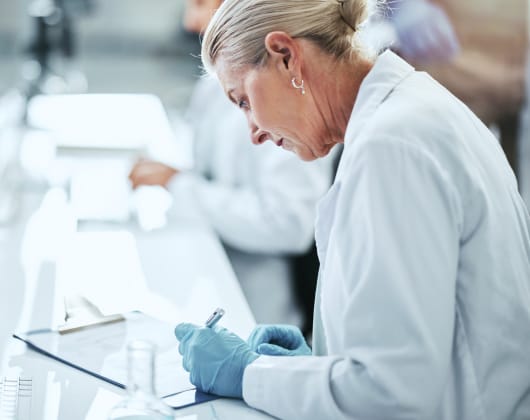 Scientist at the desk drug manufacturing 